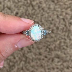 Opal ring, side stones are blue topaz and diamonds